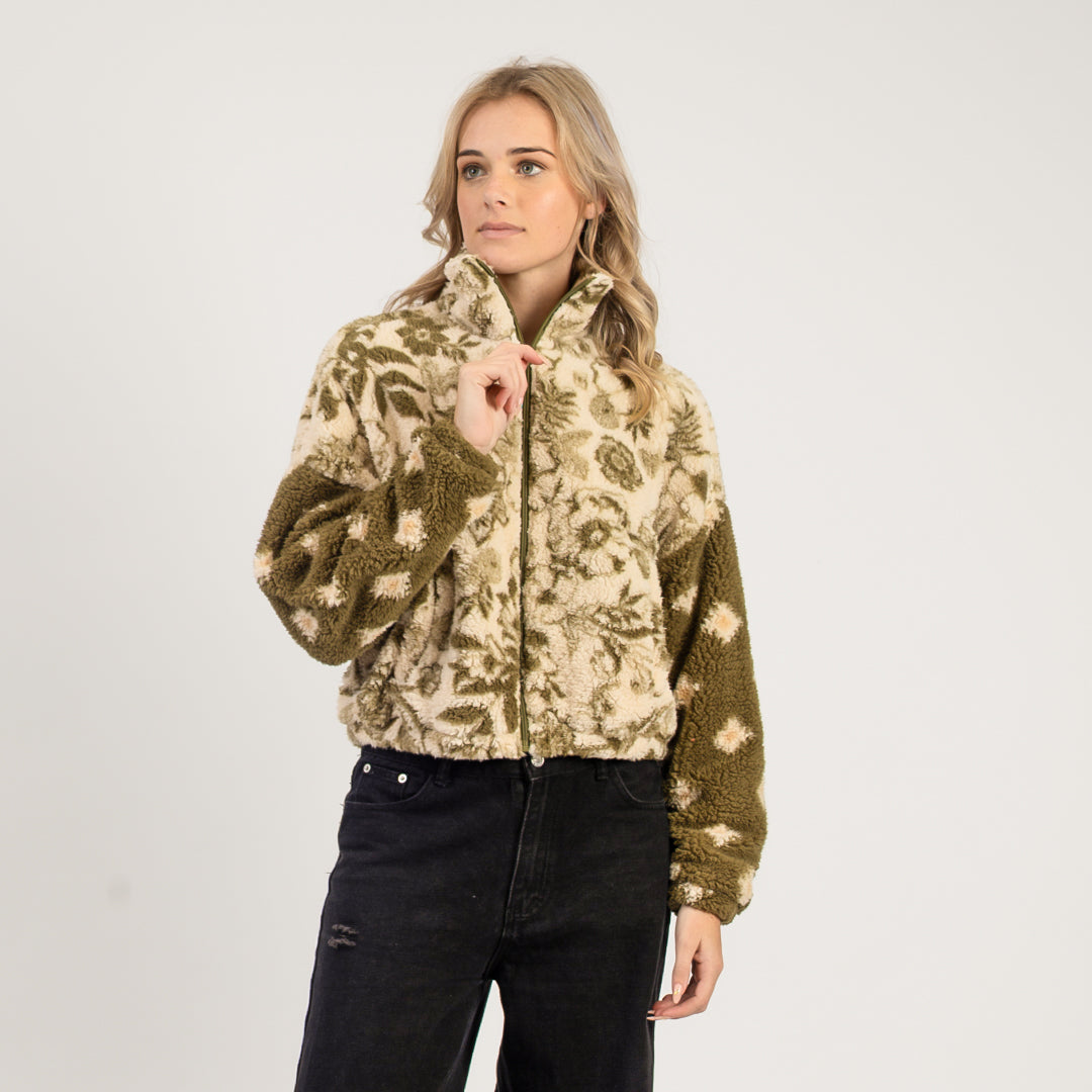 Woman wearing a patterned jacket on a white background