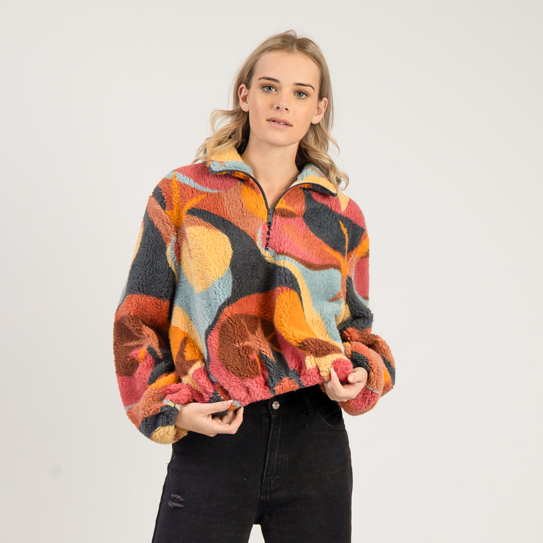 Woman wearing a colorful patterned jacket on a white background