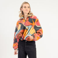 Person wearing a colorful patterned jacket on a white background