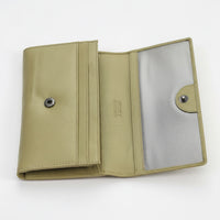Open beige wallet with metallic interior on a white background