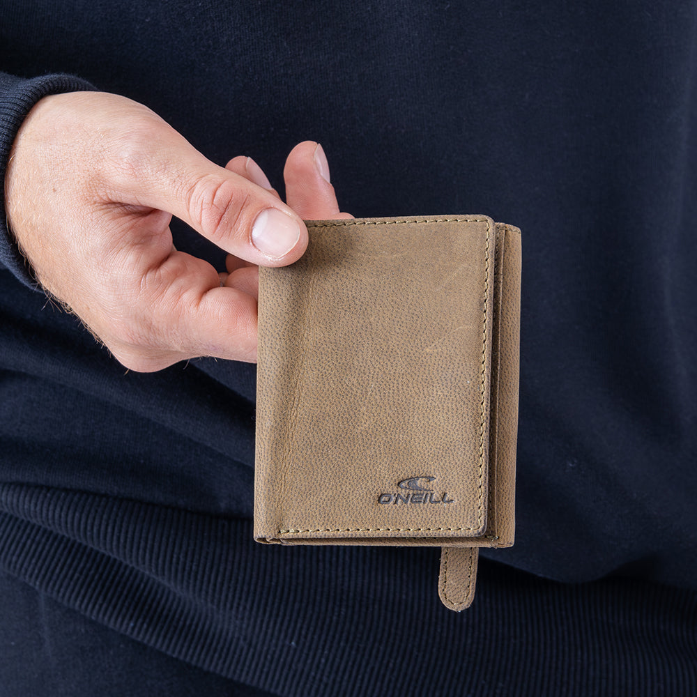 Hand holding a brown leather wallet with O'Neill logo against a dark background