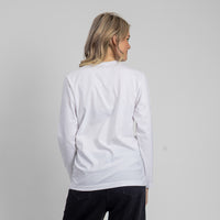 Person wearing a white sweatshirt with a plain background