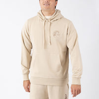 Person wearing a beige hoodie with a logo on a white background