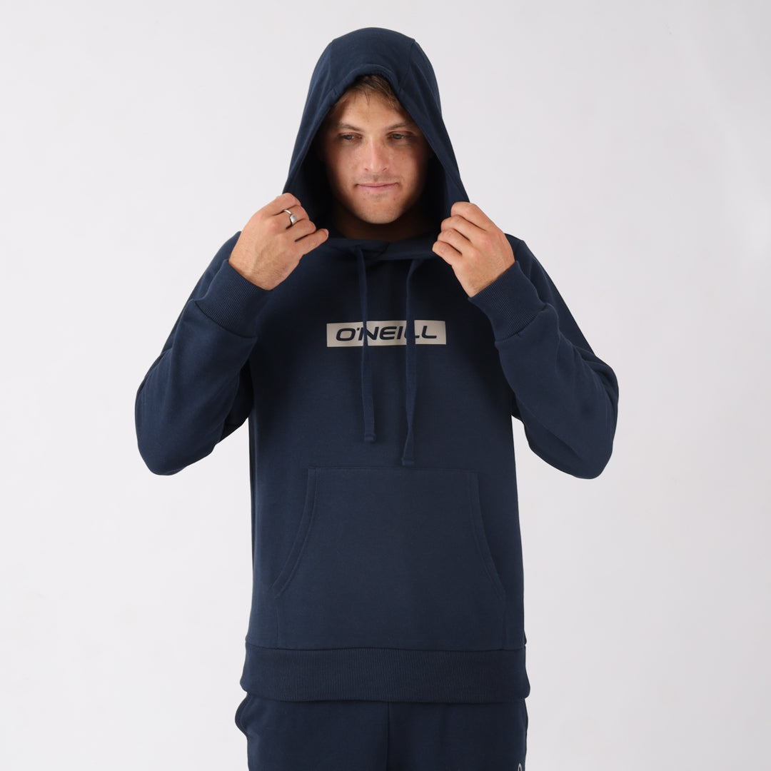 Person wearing a navy blue hoodie with a brand logo on a white background