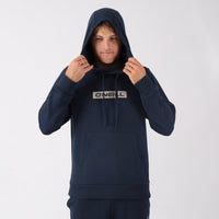 Person wearing a navy blue hoodie with a brand logo on a white background