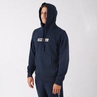 Person wearing a navy hoodie with a brand logo on a white background