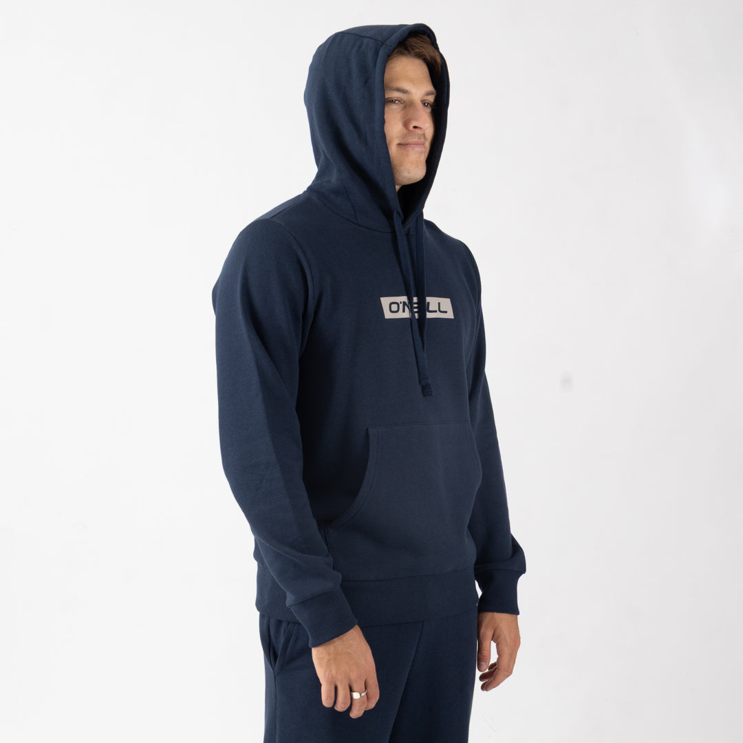 Person wearing a navy hoodie with a brand logo on a white background
