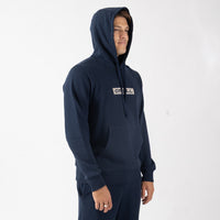 Person wearing a navy hoodie with a brand logo on a white background
