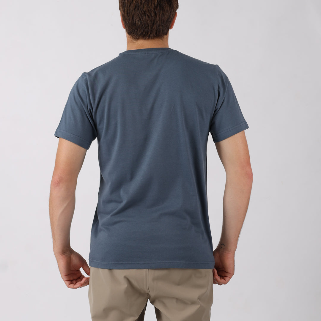 Person wearing a blue t-shirt on a plain background