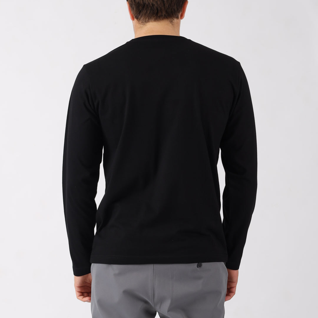 Person wearing a black long-sleeve shirt on a light gray background