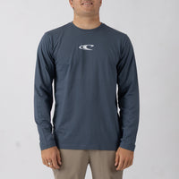 Man wearing a navy long-sleeve shirt with a logo on a light gray background
