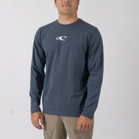 Man wearing a blue long-sleeve shirt with a logo on a white background