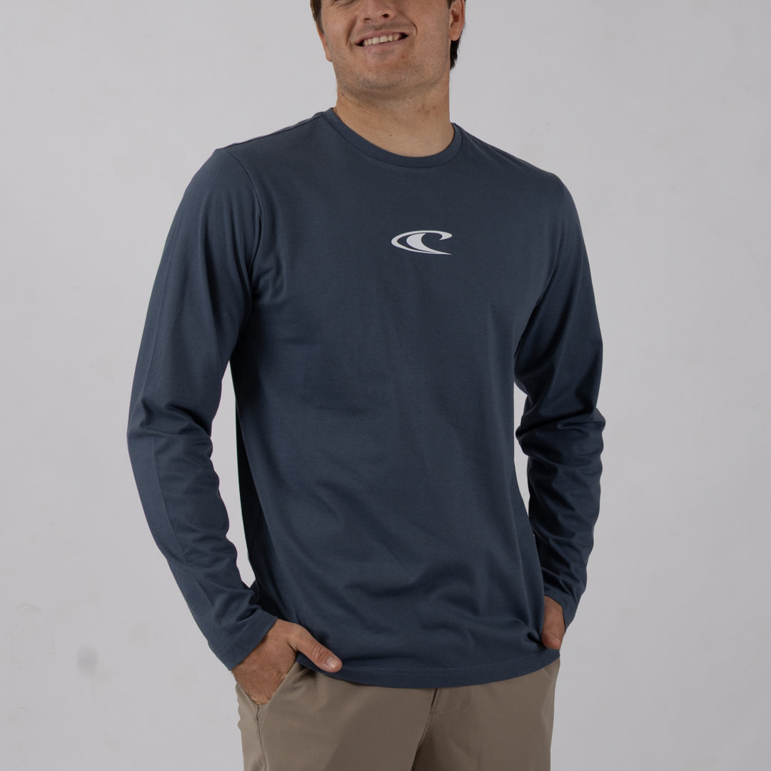 Man wearing a navy long-sleeve shirt with a logo on a plain background