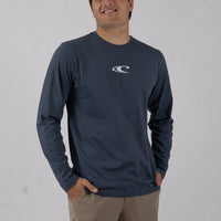 Man wearing a navy long-sleeve shirt with a logo on a plain background