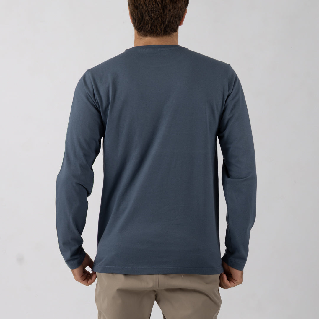 Person wearing a blue long-sleeve shirt against a white background