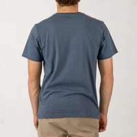 Person wearing a blue t-shirt on a plain background