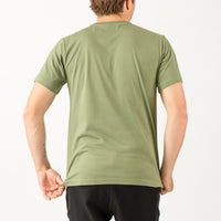 Person wearing a green t-shirt on a plain background