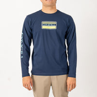 Man wearing a navy long-sleeve shirt with a logo on a white background