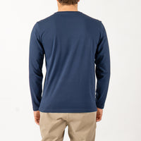 Person wearing a blue long-sleeve shirt on a white background