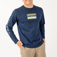 Man wearing a navy long-sleeve shirt with a logo on a white background