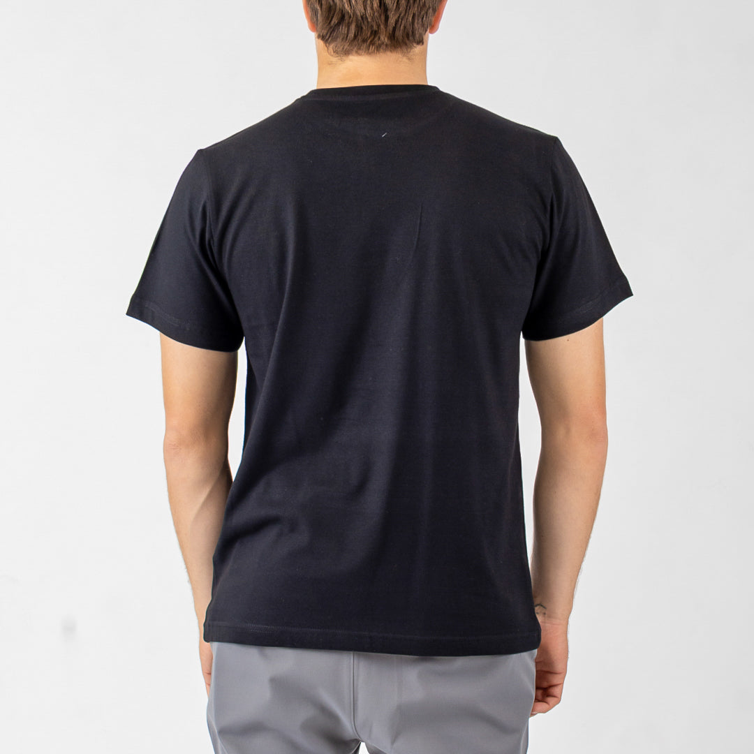 Person wearing a black t-shirt on a plain background