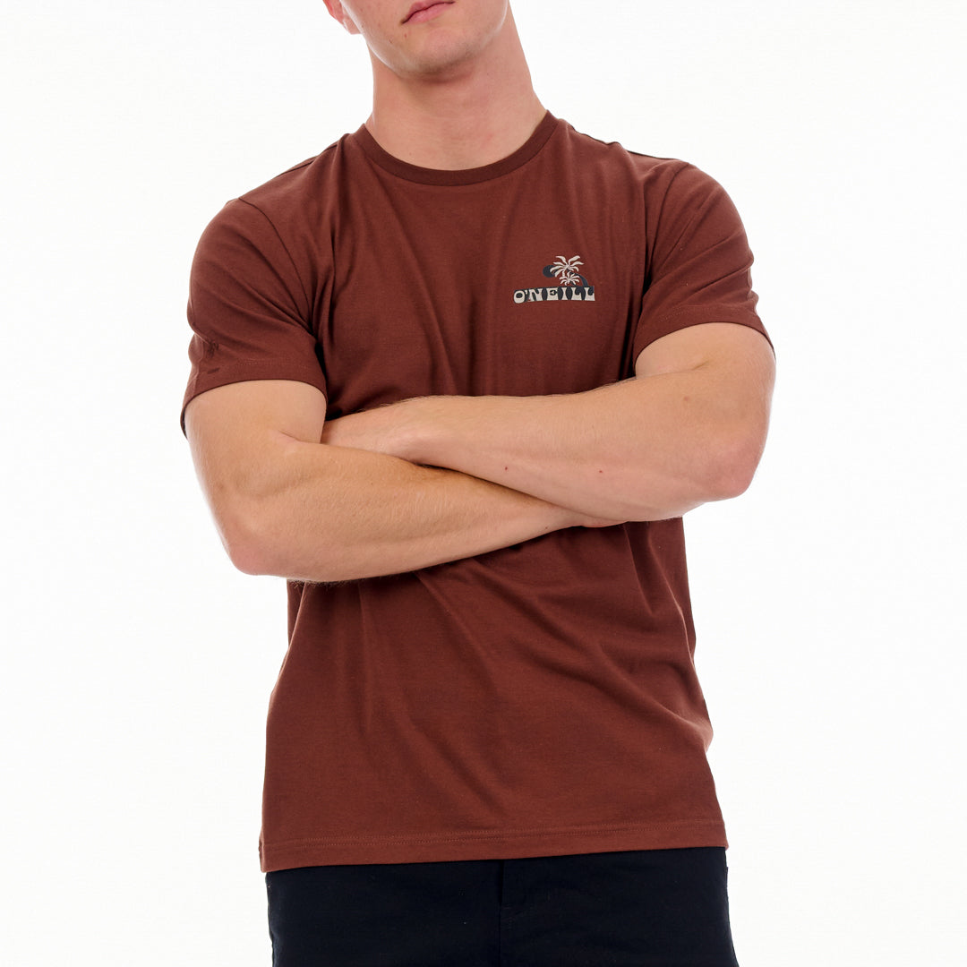 Person wearing a brown O'Neill t-shirt with arms crossed on a white background