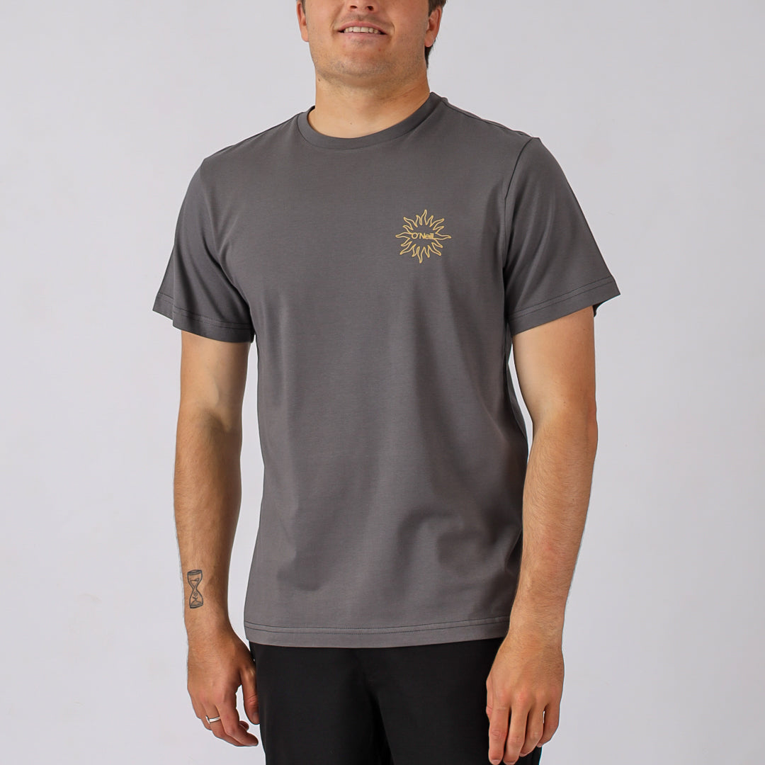 Man wearing a gray t-shirt with a logo on a plain background