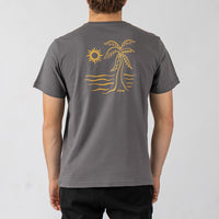 Person wearing a gray t-shirt with a yellow palm tree and sun design on the back, on a light gray background.