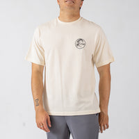 Man wearing a beige t-shirt with a logo on a white background