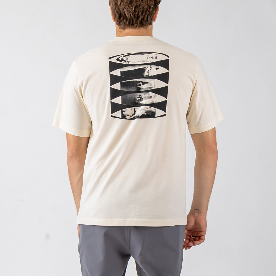 Person wearing a beige t-shirt with a graphic design on the back, standing against a plain background.