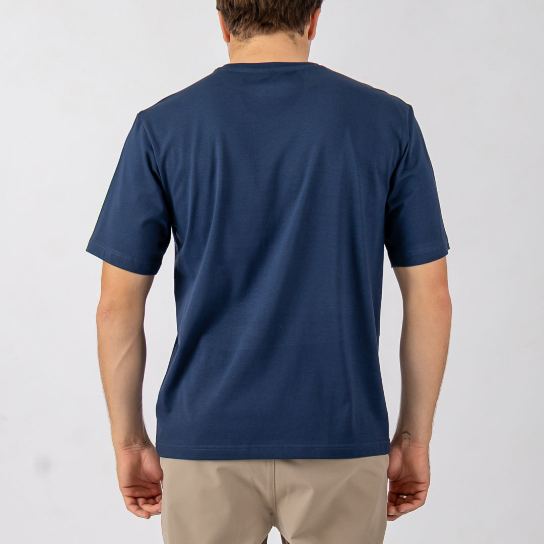 Person wearing a blue t-shirt on a plain background