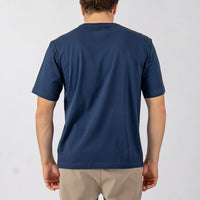 Person wearing a blue t-shirt on a plain background