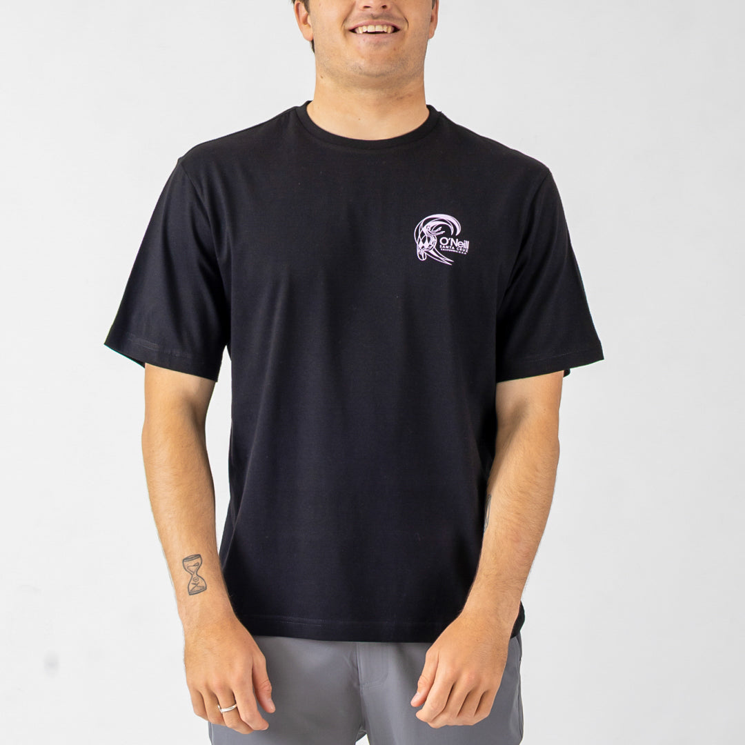 Person wearing a black t-shirt with a logo on a plain background