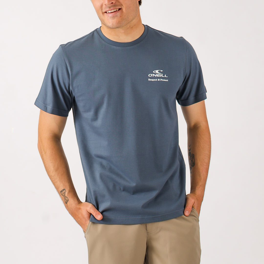 Man wearing a blue t-shirt with a logo on a white background