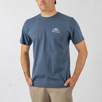 Man wearing a blue t-shirt with a logo on a white background