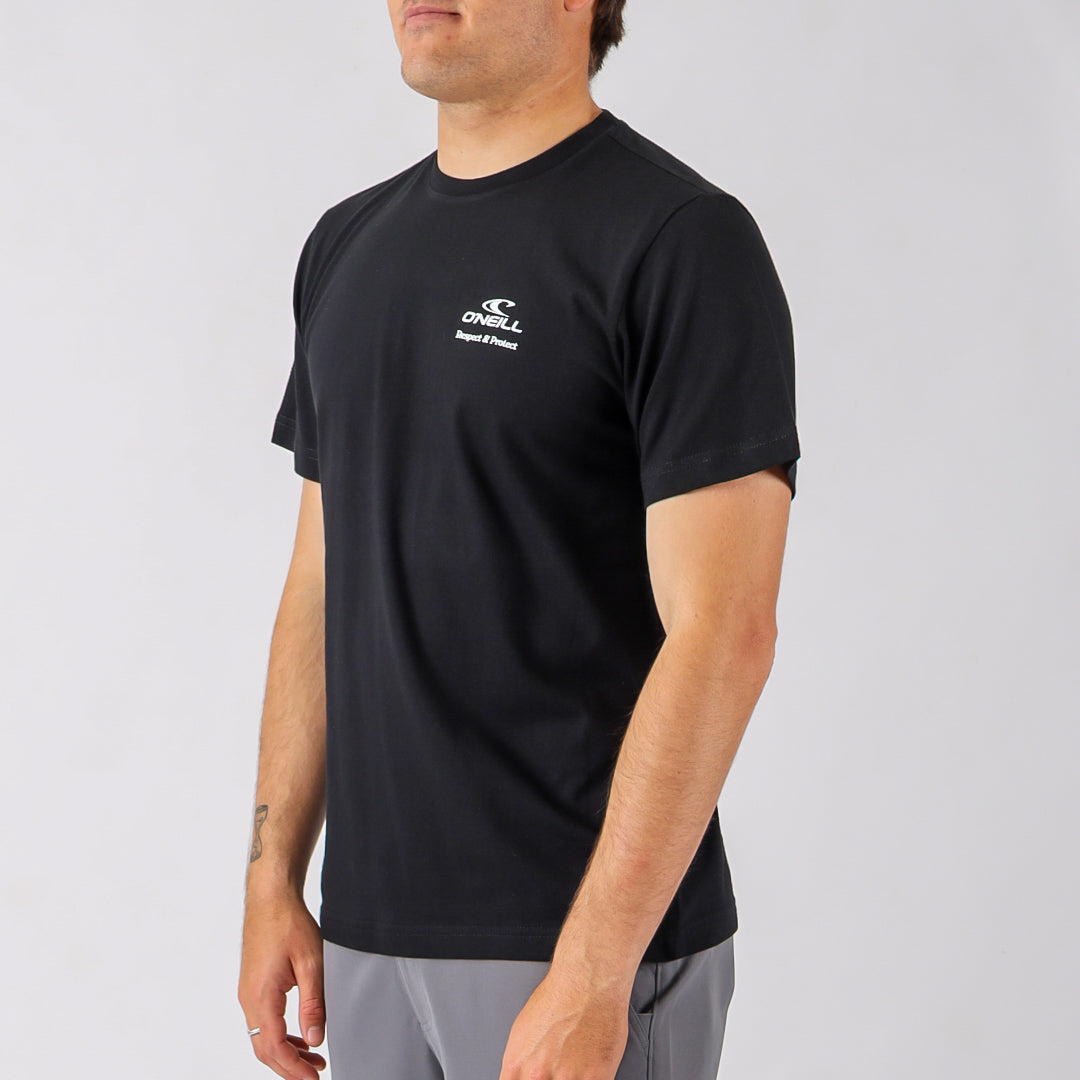 Person wearing a black t-shirt with a logo on a gray background