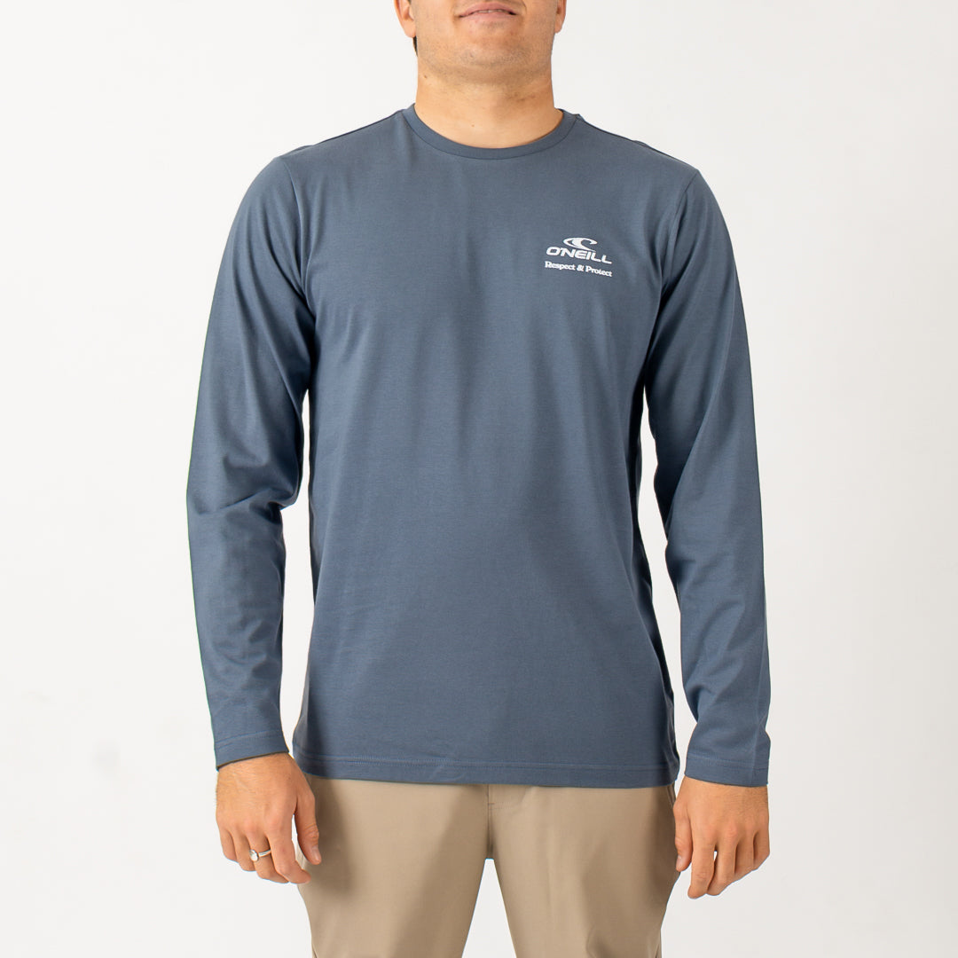 Man wearing a blue long-sleeve shirt with a brand logo on a white background