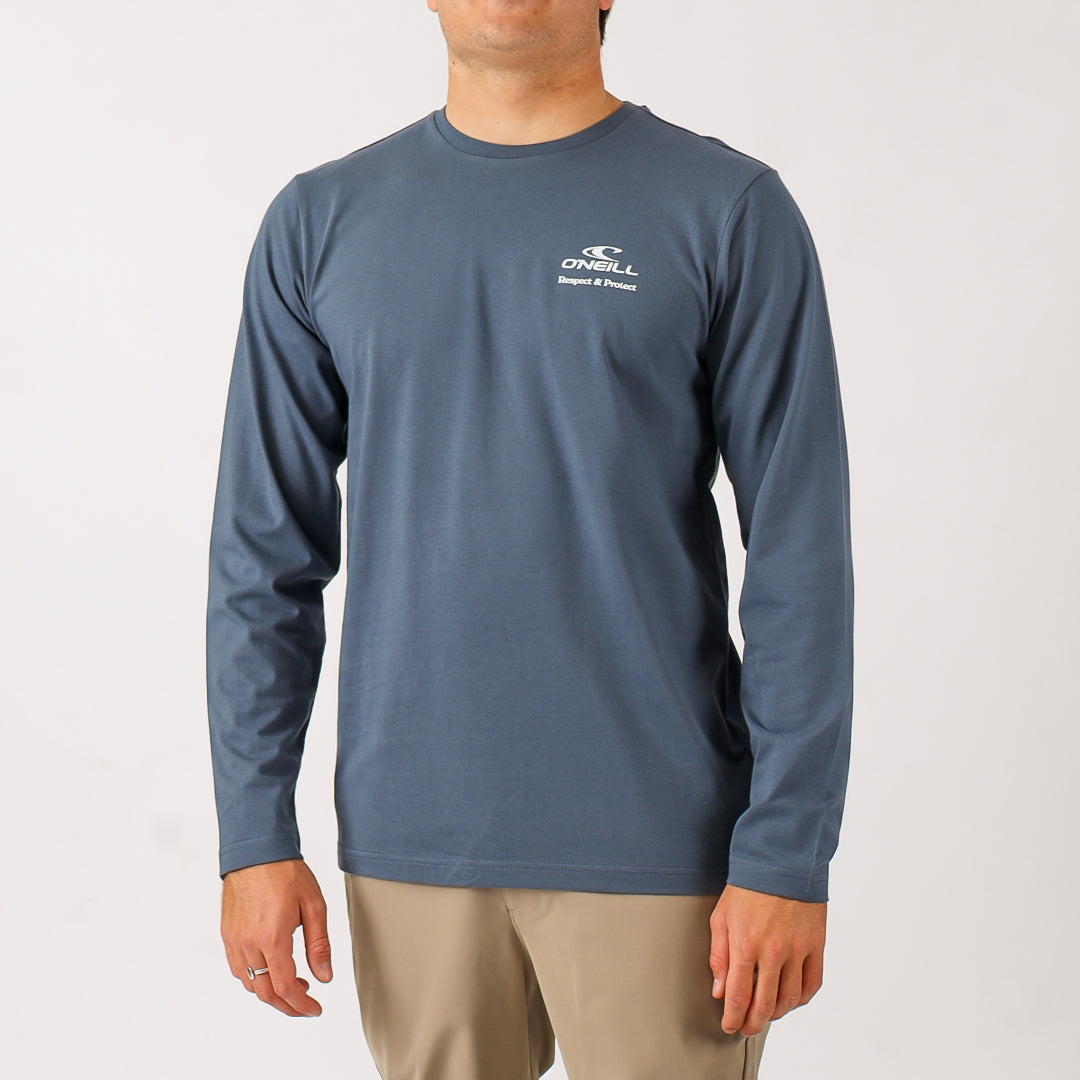 Man wearing a blue long-sleeve shirt with a logo on a white background