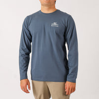 Man wearing a blue long-sleeve shirt with a logo on a white background