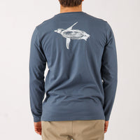 Blue long-sleeve shirt with a turtle design on the back, worn by a person.