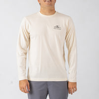 Person wearing a beige long-sleeve shirt with a logo on a white background