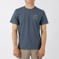 Person wearing a blue t-shirt with a small graphic on a white background