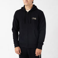 Person wearing a black hoodie with a brand logo on a white background