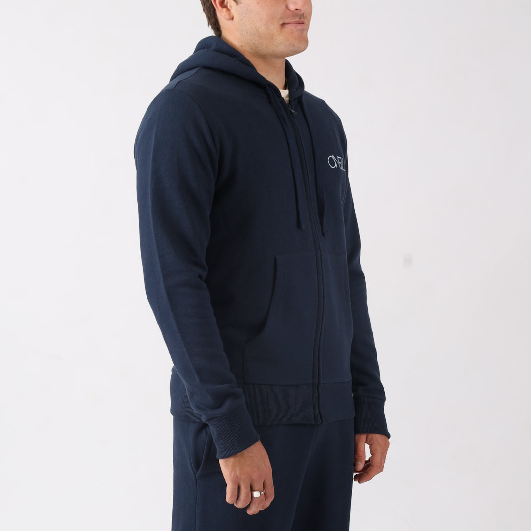 Man wearing a navy blue hoodie with a brand logo on a white background
