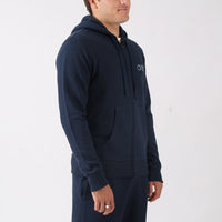 Man wearing a navy blue hoodie with a brand logo on a white background