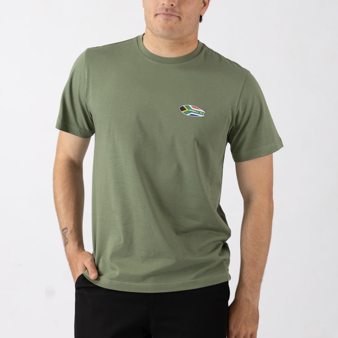 Person wearing a green t-shirt with a small logo on a white background
