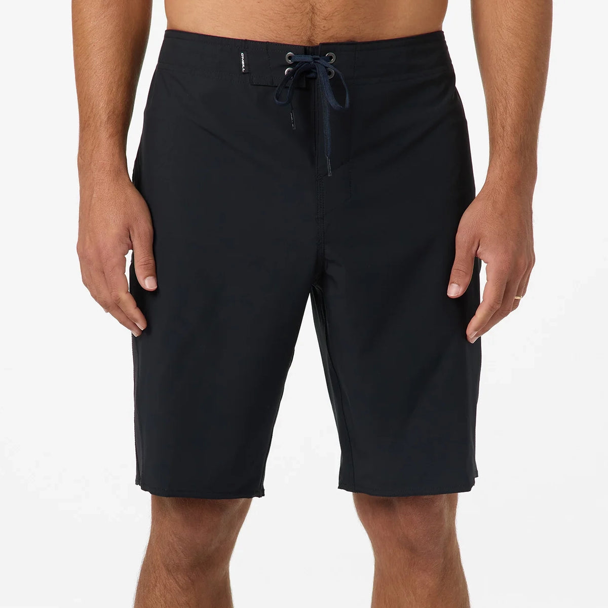 Black shorts worn by a person on a white background