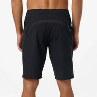 Black athletic shorts worn by a person on a white background