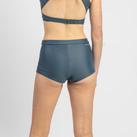 Person wearing a blue bikini set on a white background